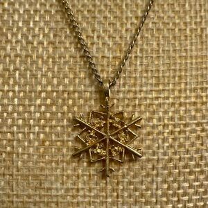 Gold Snowflake Pendant Necklace with floral clasp
